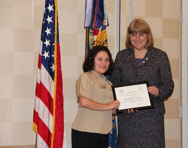 Teresa Duvall, chapter president, presents the January Military Cyber Professional Award to Petty Officer Second Class Claudia C. McGuire, USN, Naval Computer Telecommunications Area Master Station, Atlantic.